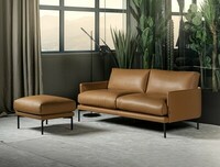 Sofa Ravel w naturalnej brązowej skórze, w zestawie z puf z tej samej kolekcji, smukłe metalowe nogi, nowoczesny design, oferowany w szerokiej gamie tkanin i skór